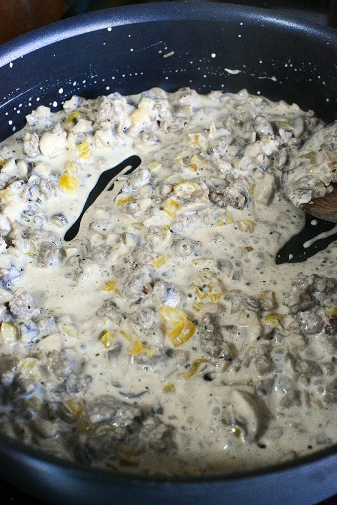 The sausage mushroom and creamy cheese sauce in the fry pan.