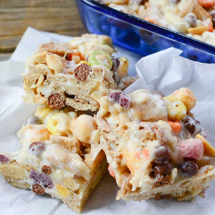 Ooey gooey cereal treat bars huddled together on a white napkin.
