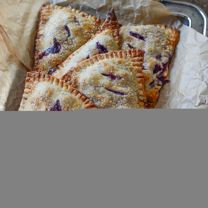 These pretty hand pies displayed in a vintage silver tray with rustic paper around them scream rustic deliciousness!