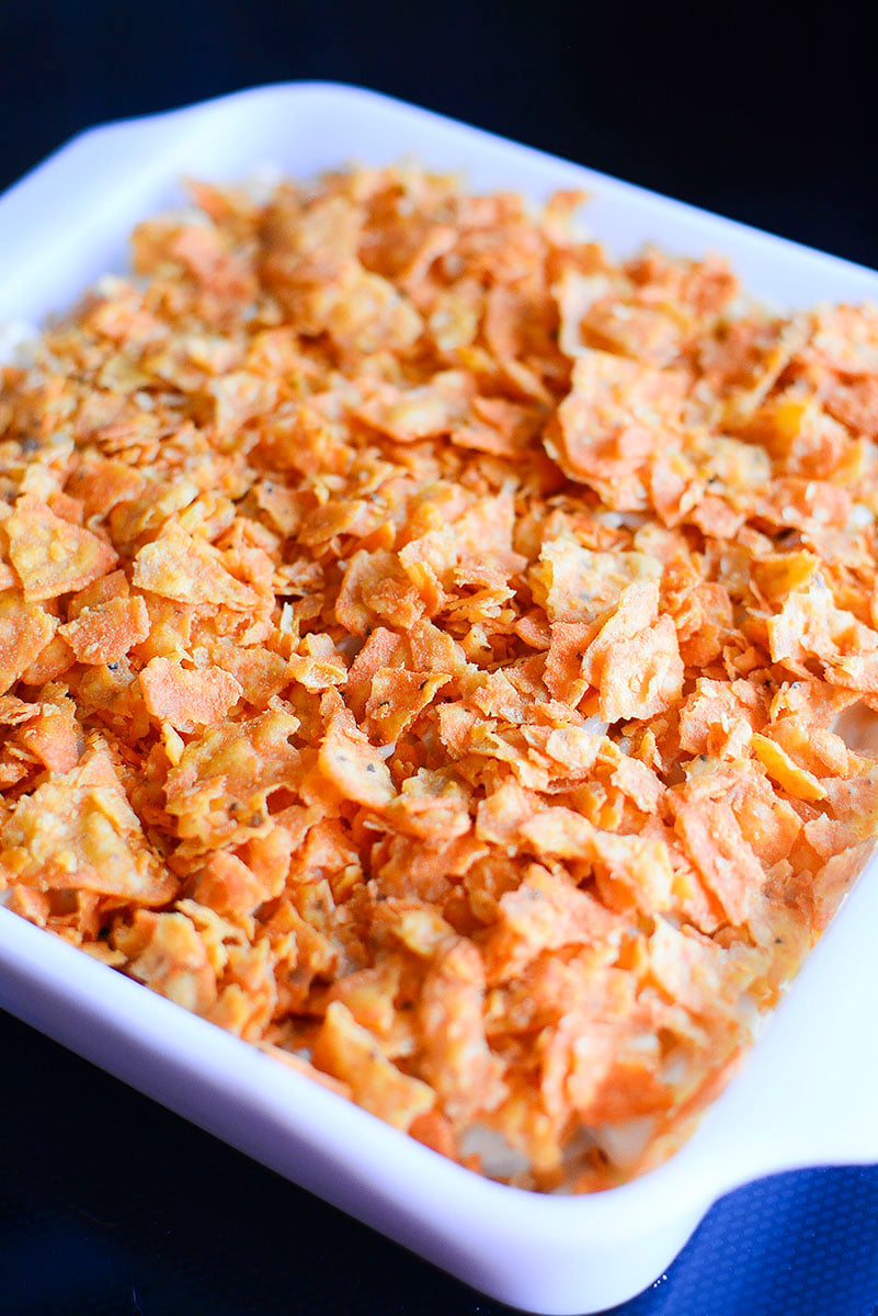 Unbaked doritos mac and cheese in a baking dish.