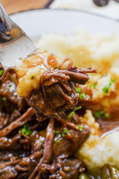 Mississippi Pot Roast with mashed potatoes on a white plate.
