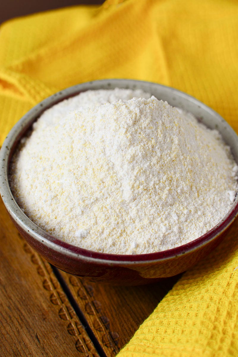 Cornbread muffin dry mix in a bowl with a yellow napkin.