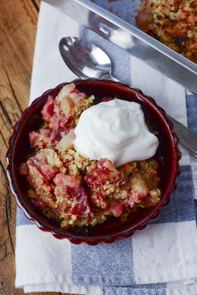 A serving of dessert in a brown dish, sitting on a blue and white napkin. Delicious!