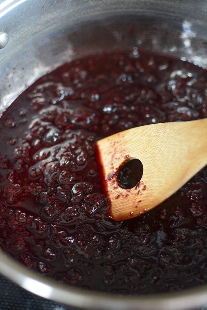 Stirring the pot of sour cherries after they've simmered and broken down into a sort of jam texture.