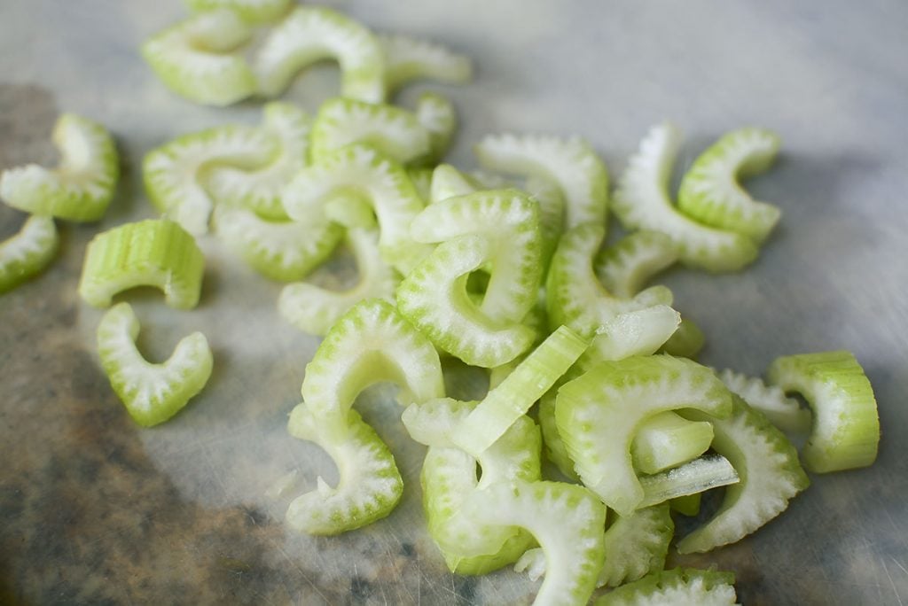 Celery cut in half moon shapes.