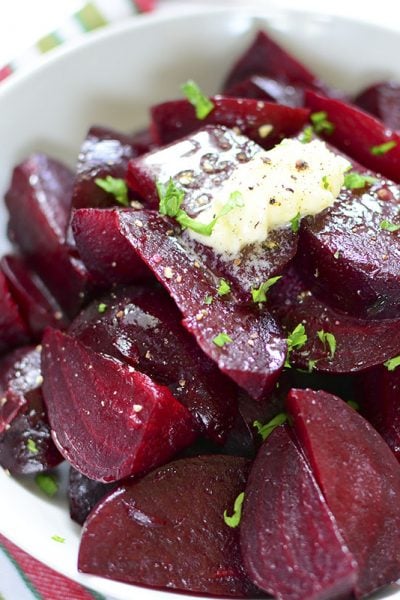 Beets in a white bowl with butter on top.