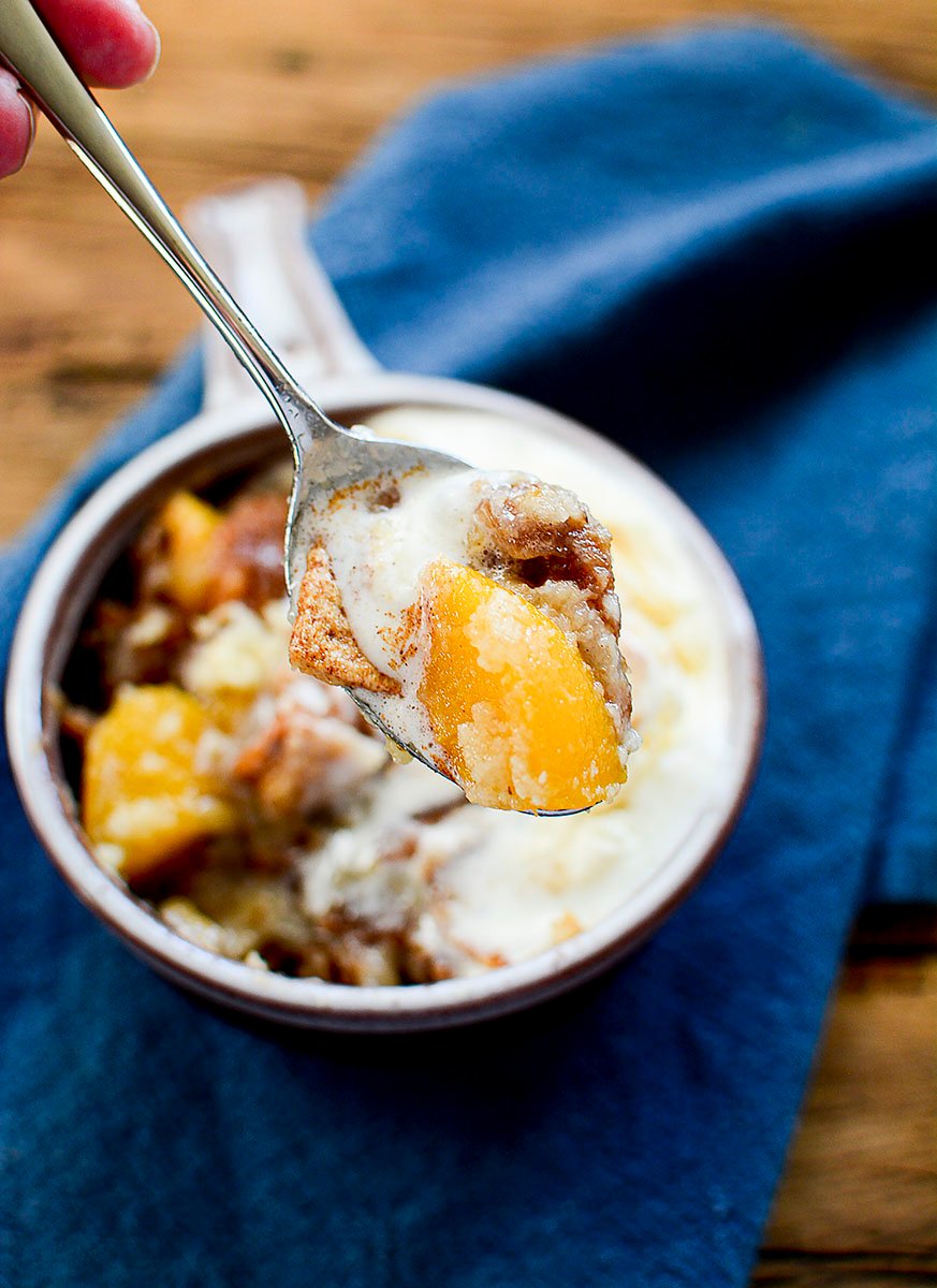 A spoonful of the peach cobbler served with ice cream. 