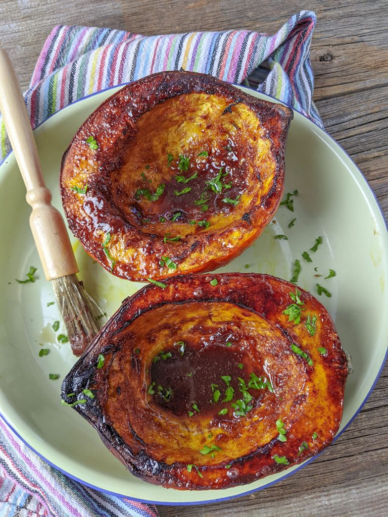 Acorn squash with a cinnamon butter glaze on the top.