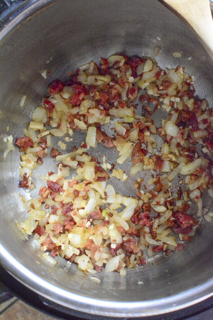 Bacon is added to the onions.