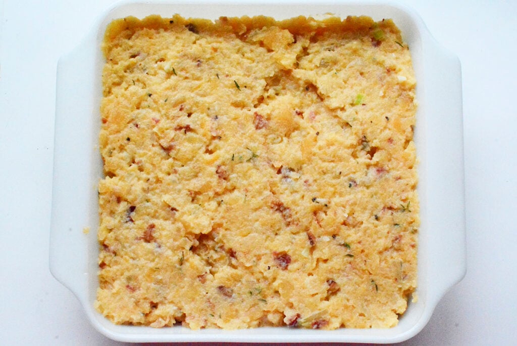 The mixture is added to the baking dish. 