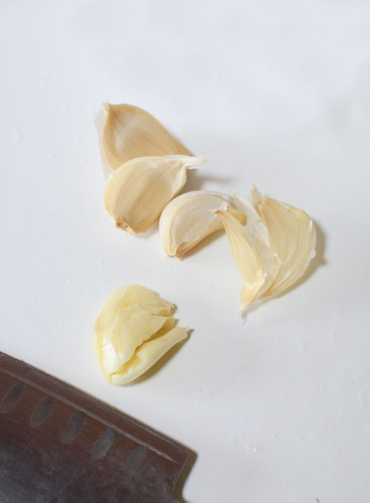 Garlic being peeled and chopped. 
