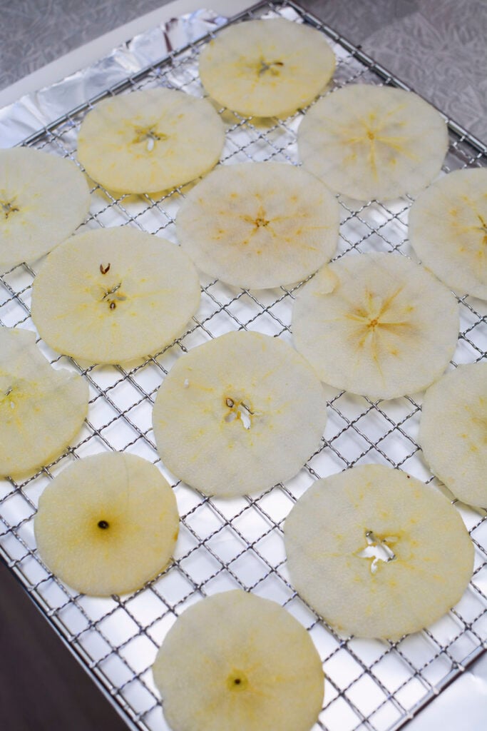 Sliced apples on the metal tray, ready for seasoning.