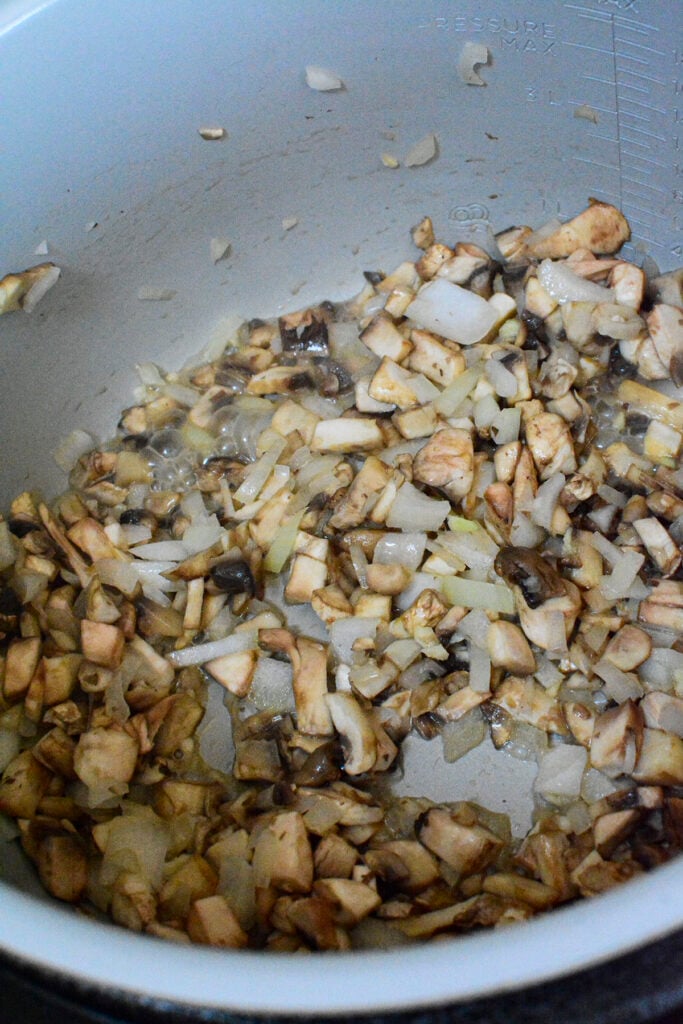 Mushrooms and onions being sauteed.