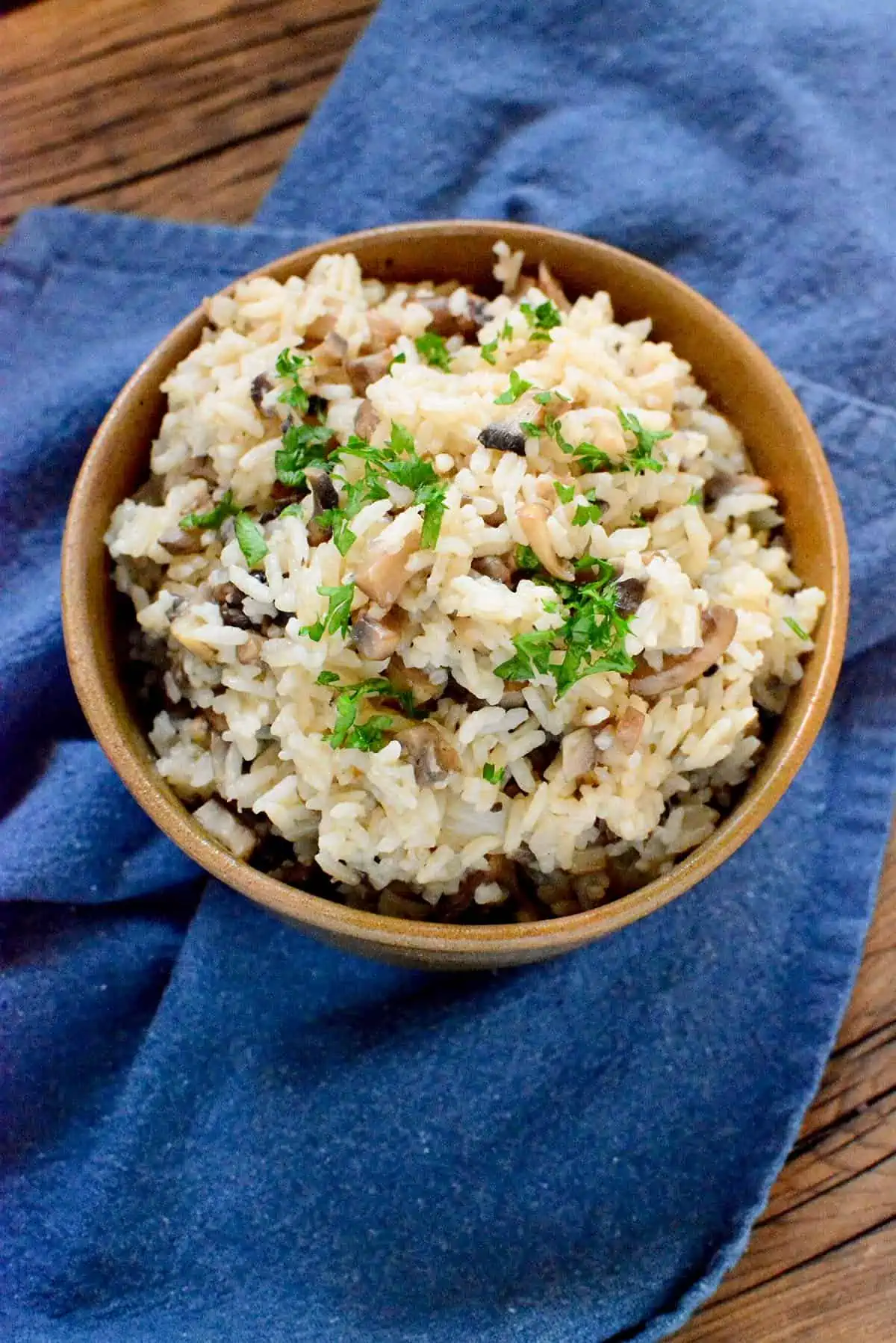 Rice in a bowl on a blue napkin.