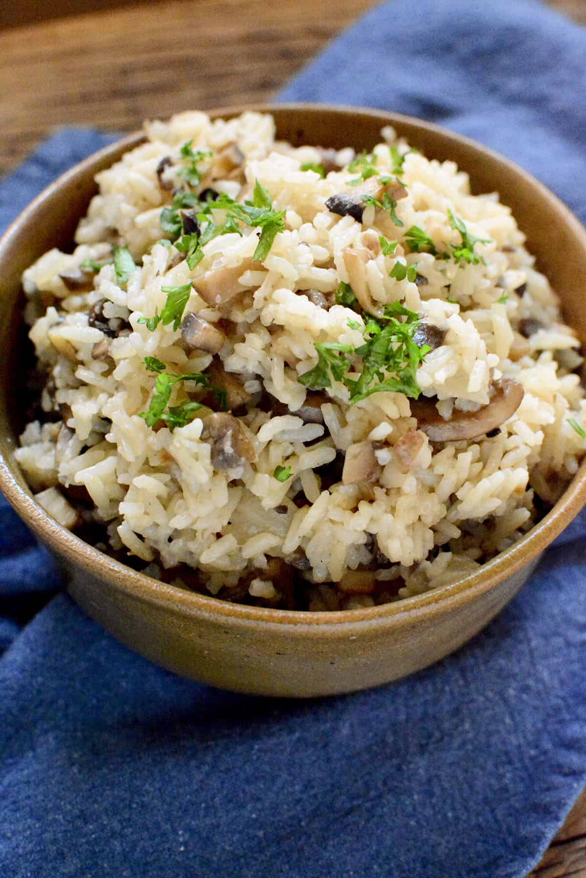 Mushroom rice in a brown bowl.