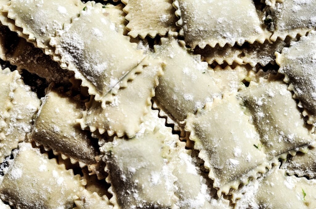 Freshly made ravioli with flour sprinkled over top. 