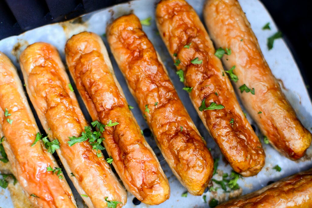 air fryer breakfast sausage in the air fryer basket.