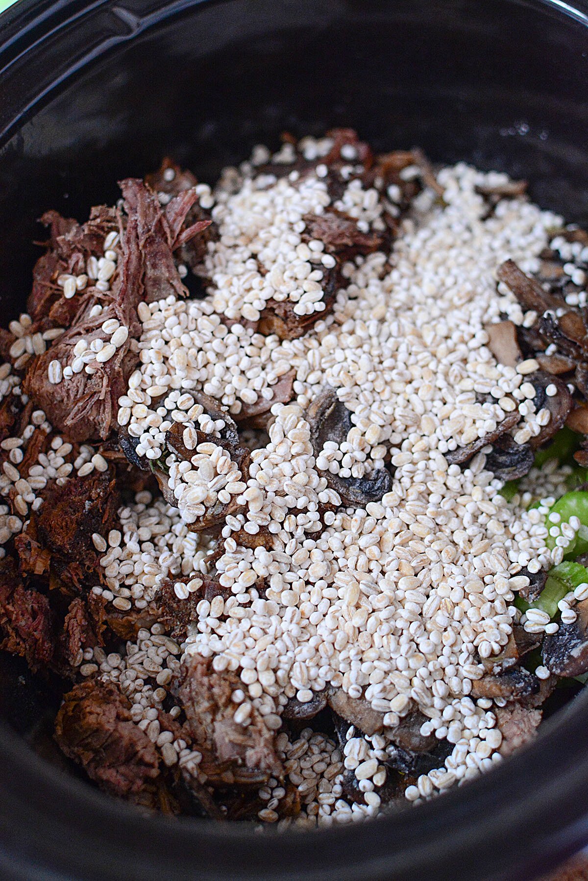 Pearled barley on top of beef and veggies.