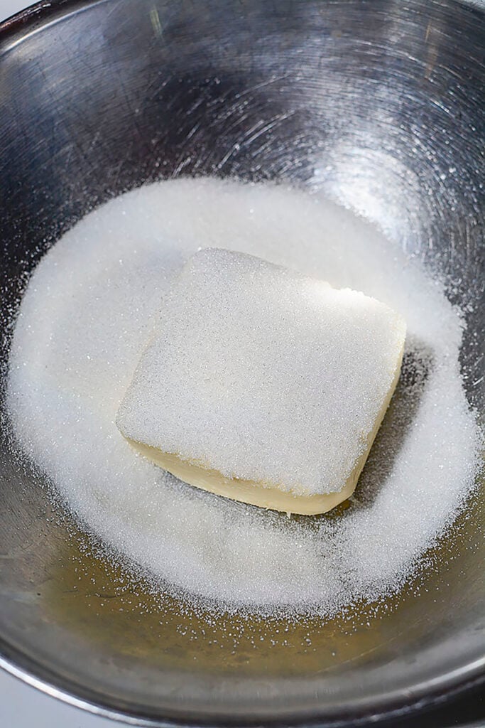 Butter and sugar in a steel bowl.