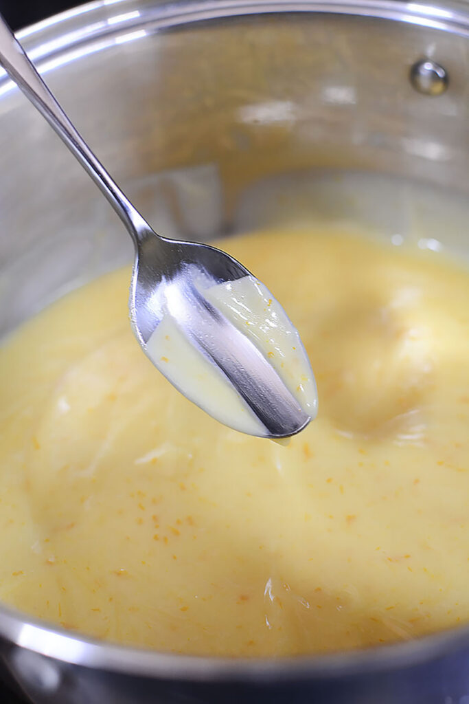 The mixture is thick enough when a finger is pulled through a spoonfull of curd and it doesn't come back together.