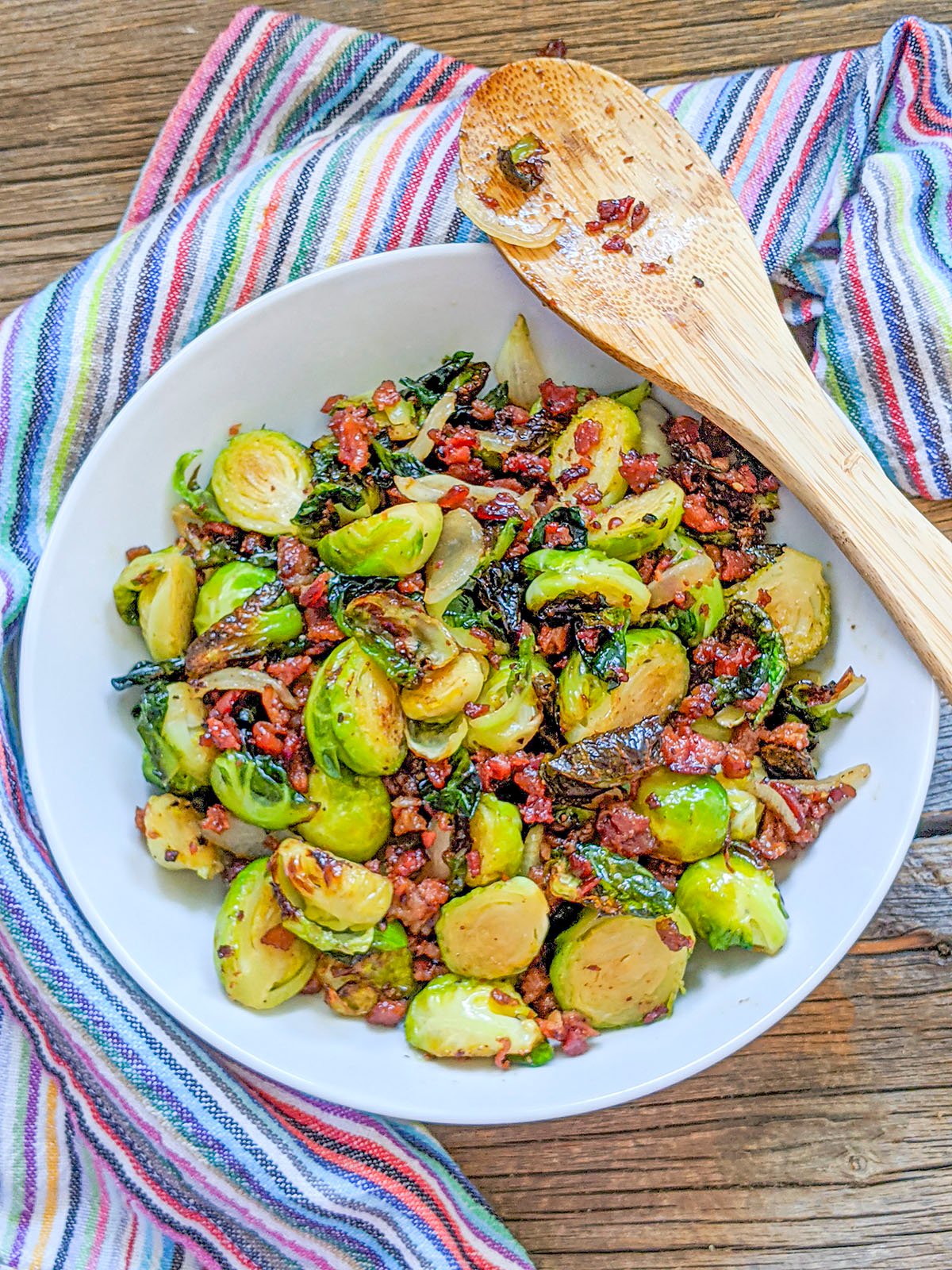 Ninja Foodi Brussel Sprouts with bacon in a white bowl. 