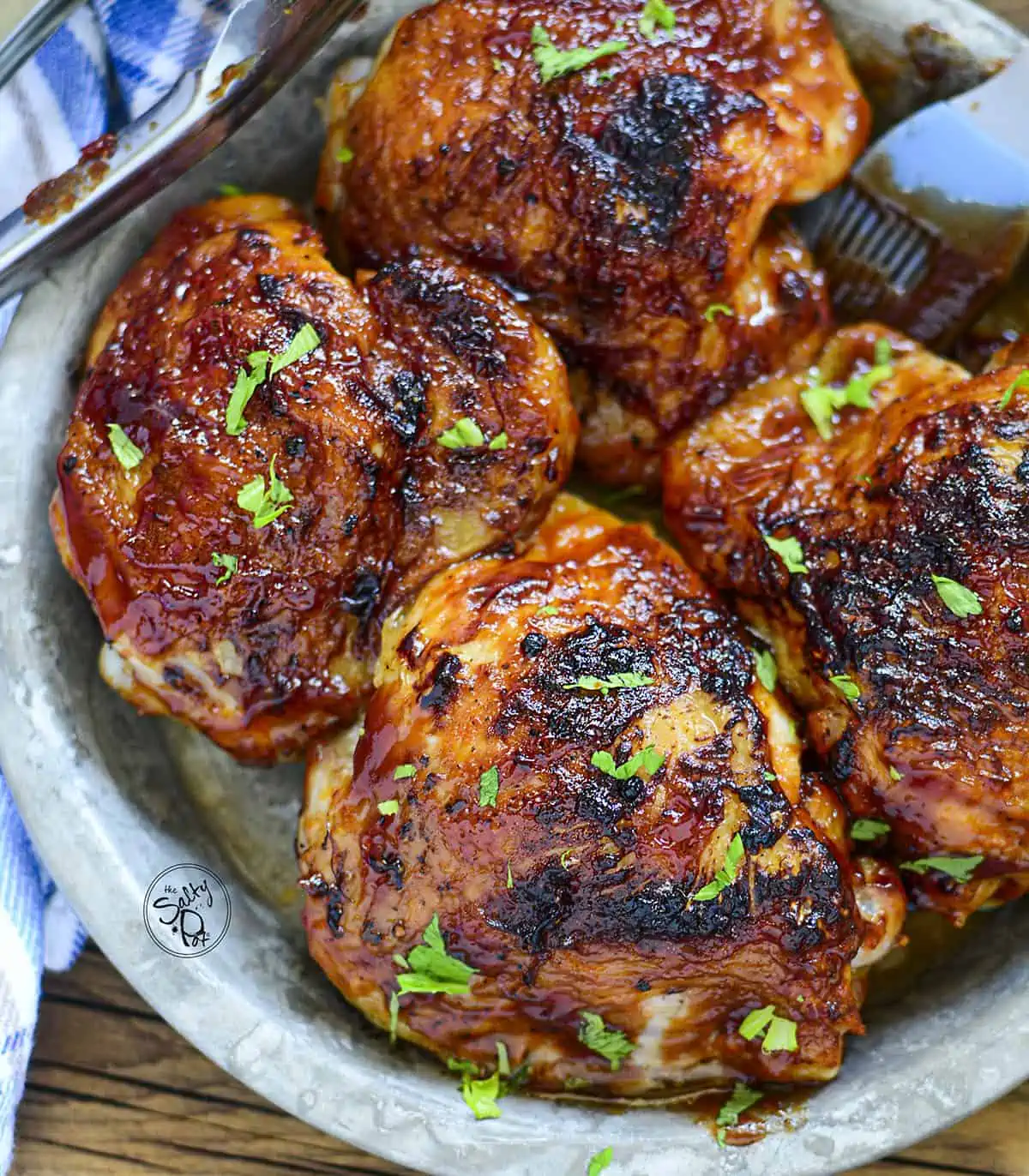 4 air fried chicken thighs sitting in a metal pan ready to be served.