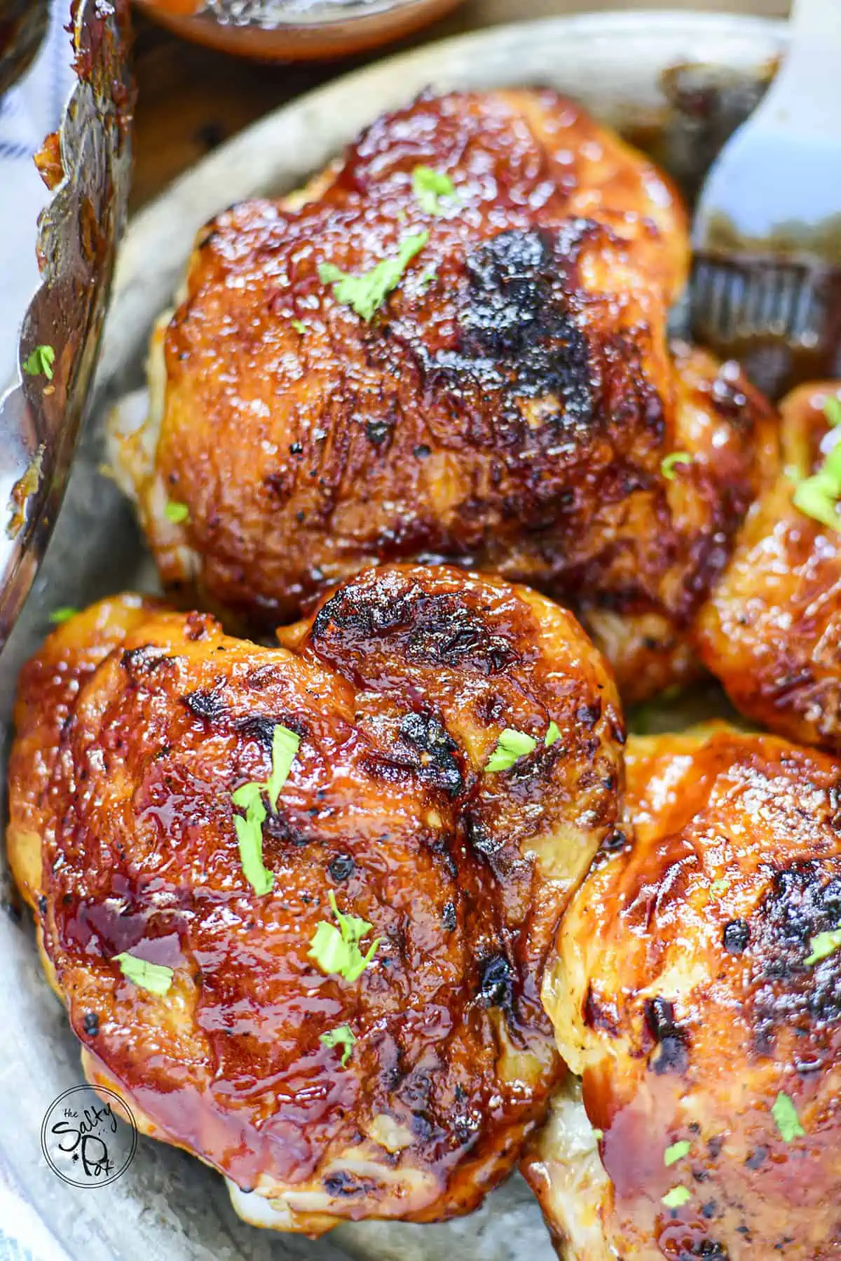 Two chicken thighs photographed close up on a plate.