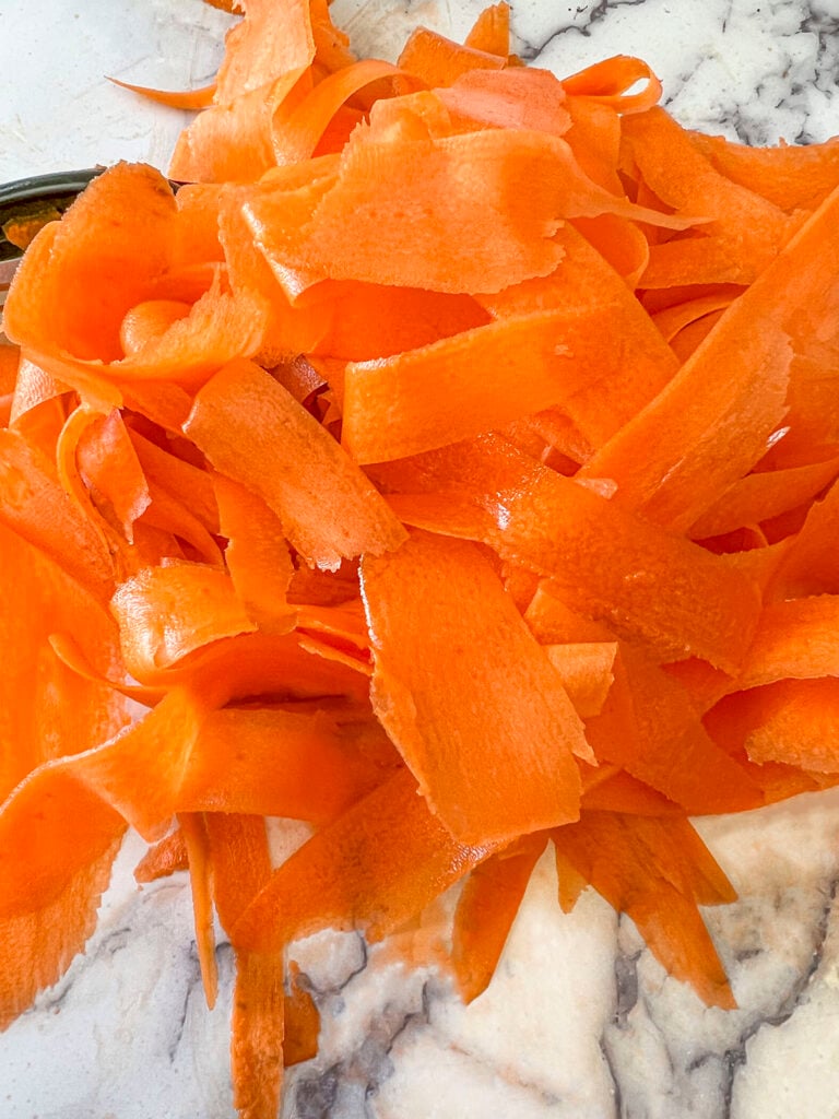 Shaved carrot on a marble board.