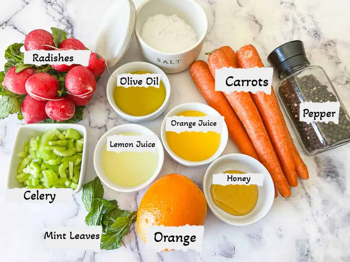 All the ingredients needed to make the carrot salad with labels. 