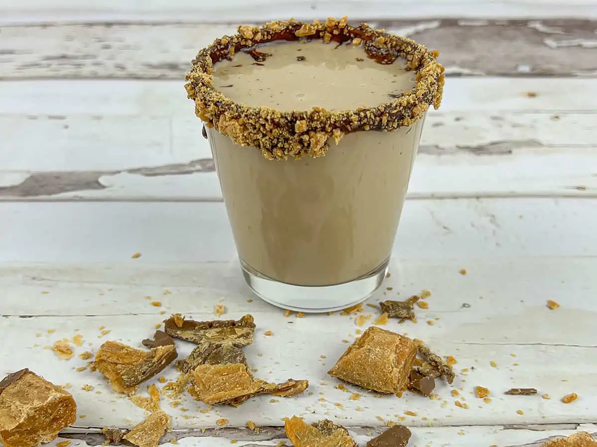 The butterfinger shooter is complete, sitting on a vintage table.