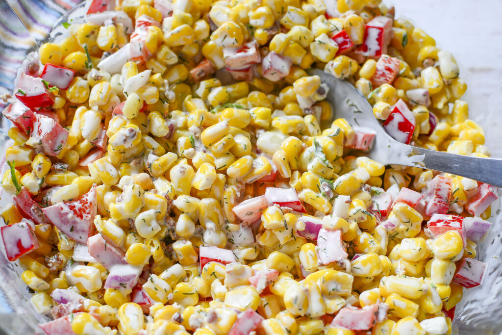 A close up of the corn salad with a creamy dressing.