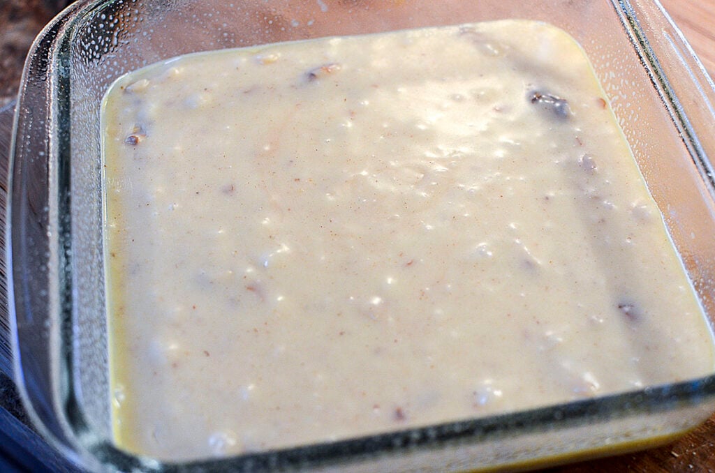 The fudge freshly poured into a white baking dish to put into the fridge and chill.