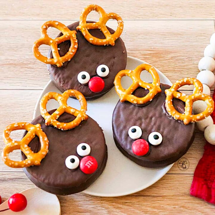 Three Reindeer Wagon Wheel Cookies on a white plate.