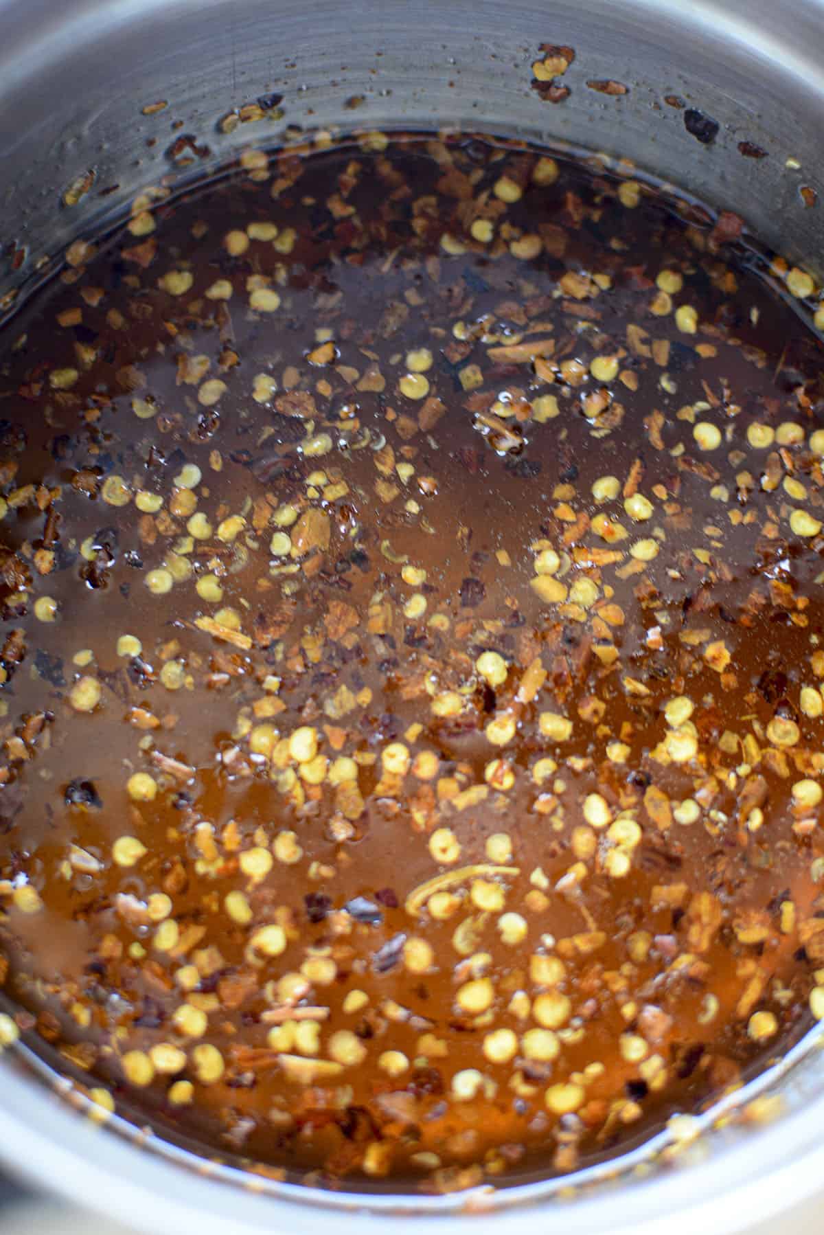 The hot honey is heated and infused in a pot. Ready to be bottled up.