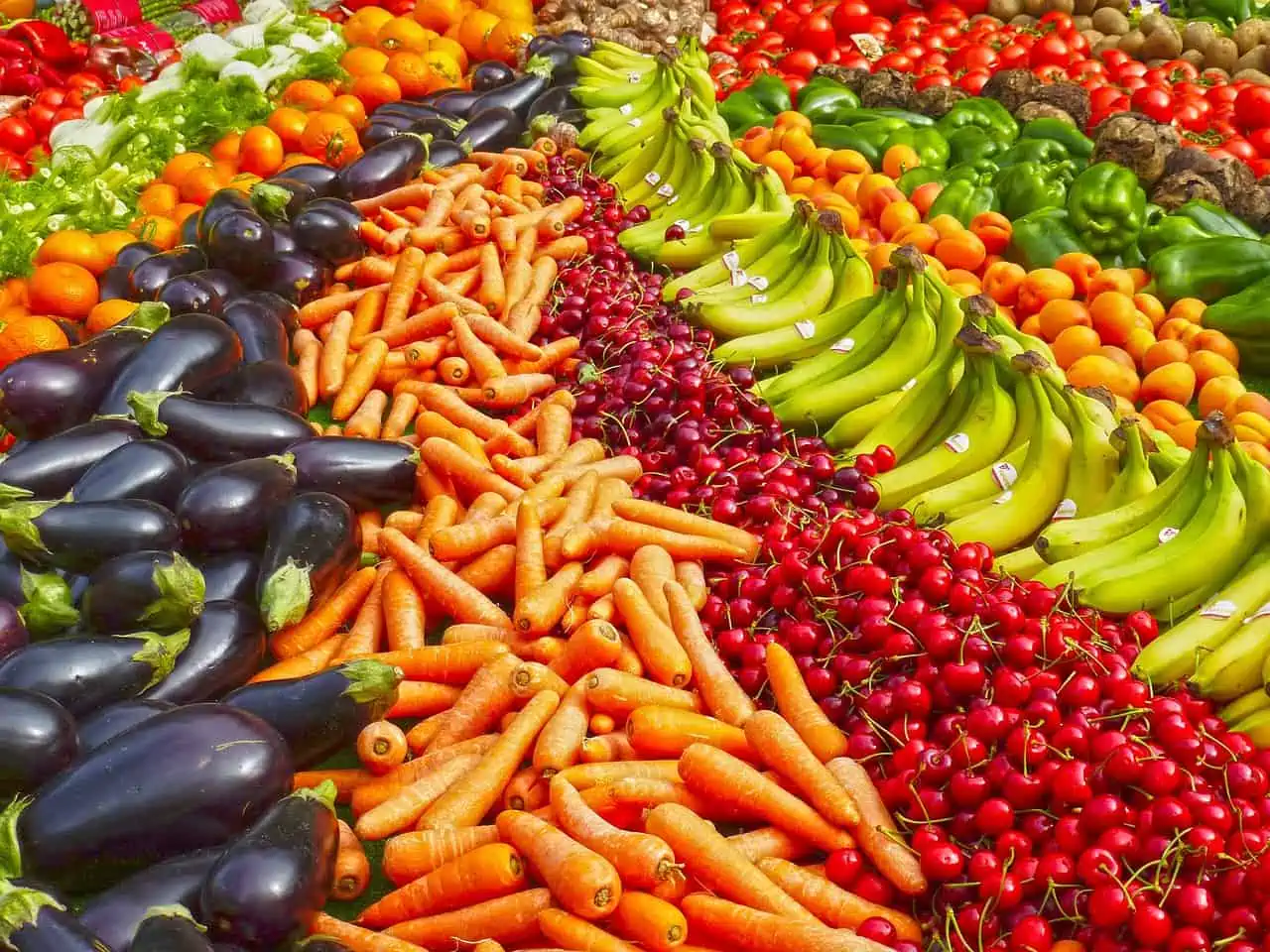 An array of fruits and vegetables at a market.