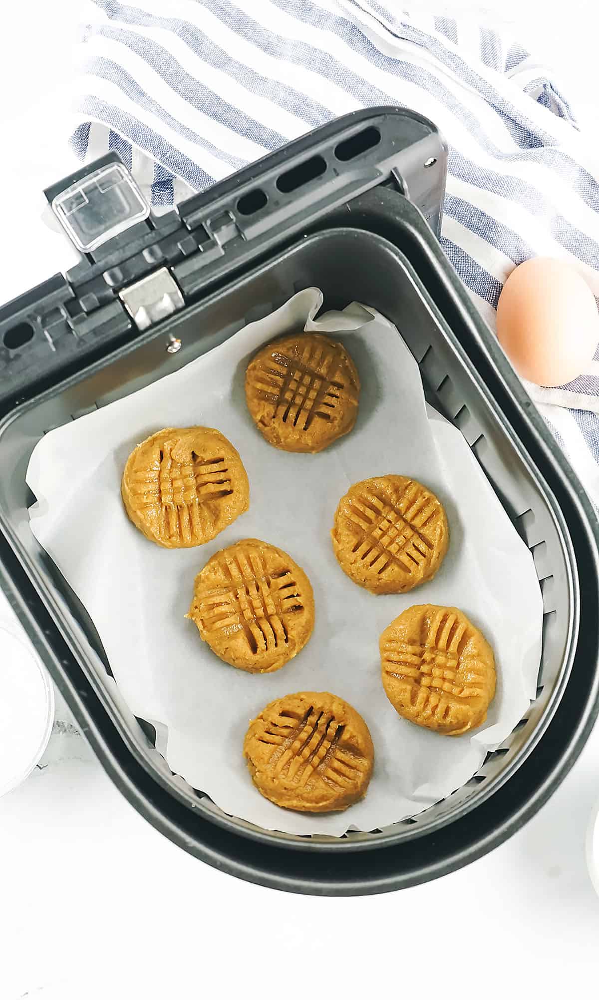 Air Fryer Peanut Butter Cookies ion the air fryer before cooking.