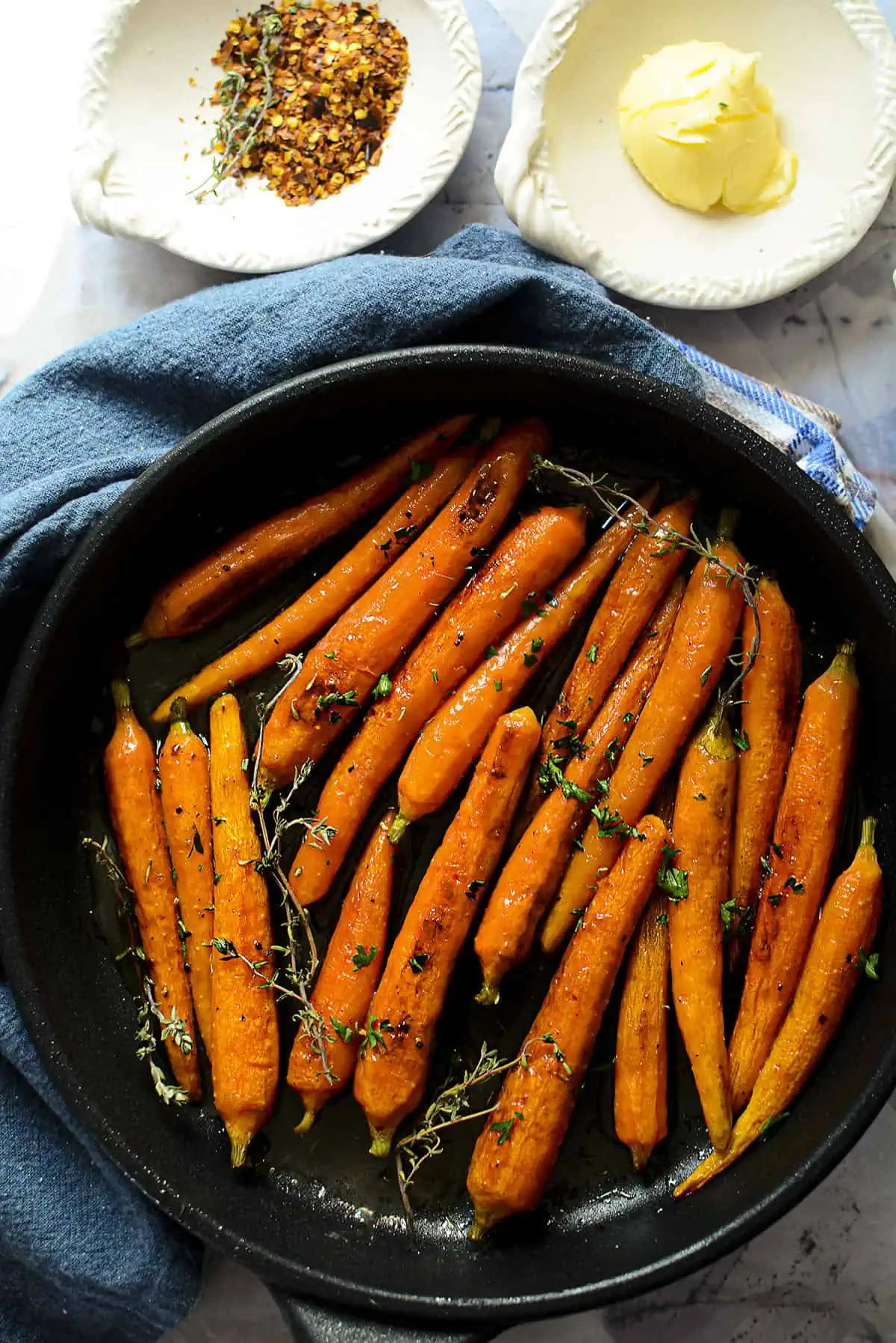 Hot honey roasted carrots in cast iron skillet.