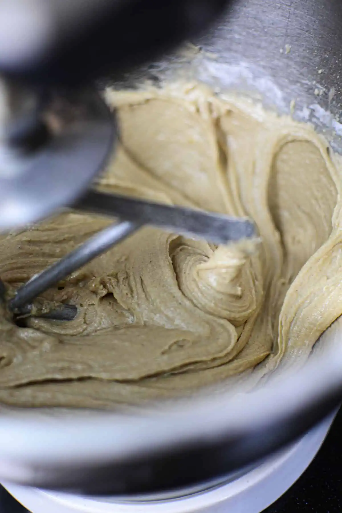 Mixing  the sugar and eggs in an electric mixer.