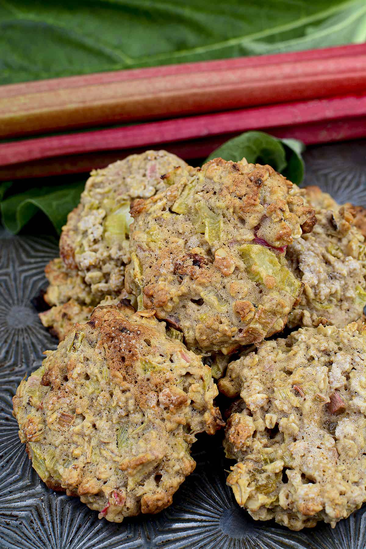 rhubarb cookies piled on eachother on a metal baking sheet.