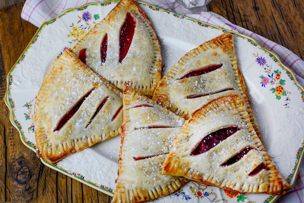 Strawberry Rhubarb Hand Pies on a decorative plate.