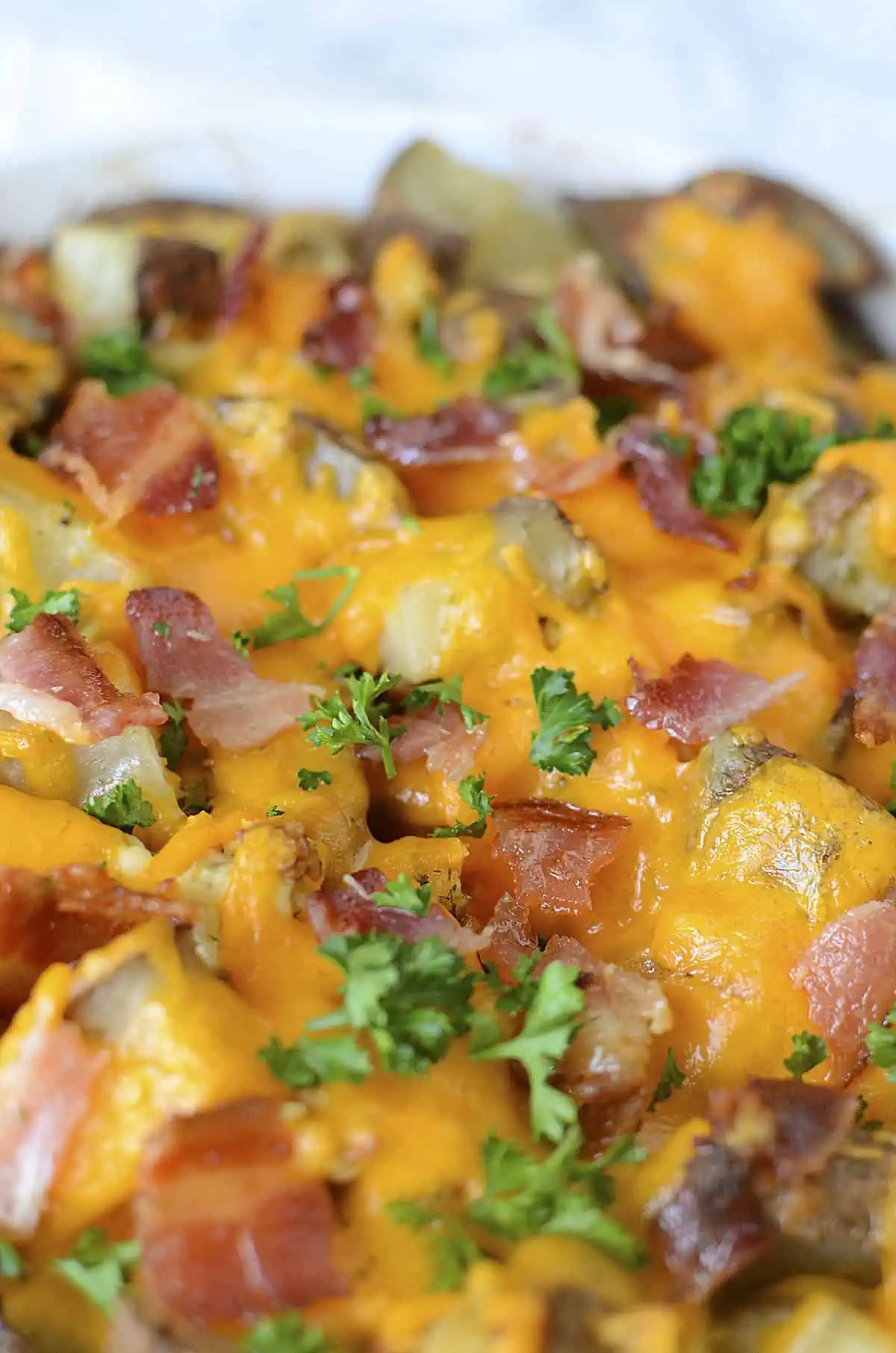 Loaded chicken bacon potato bake close up in the baking dish.