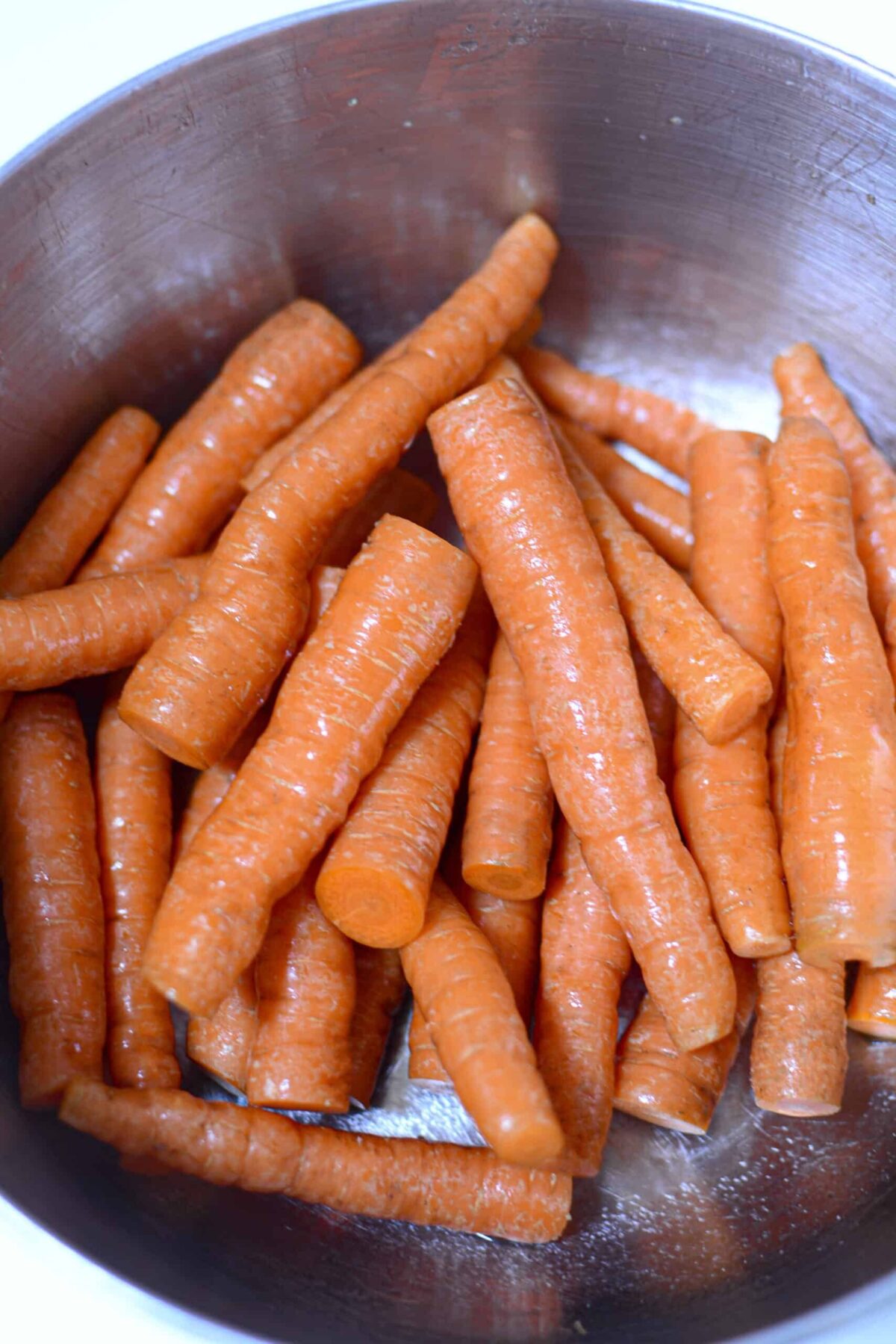 Fresh carrots in a silver bowl.