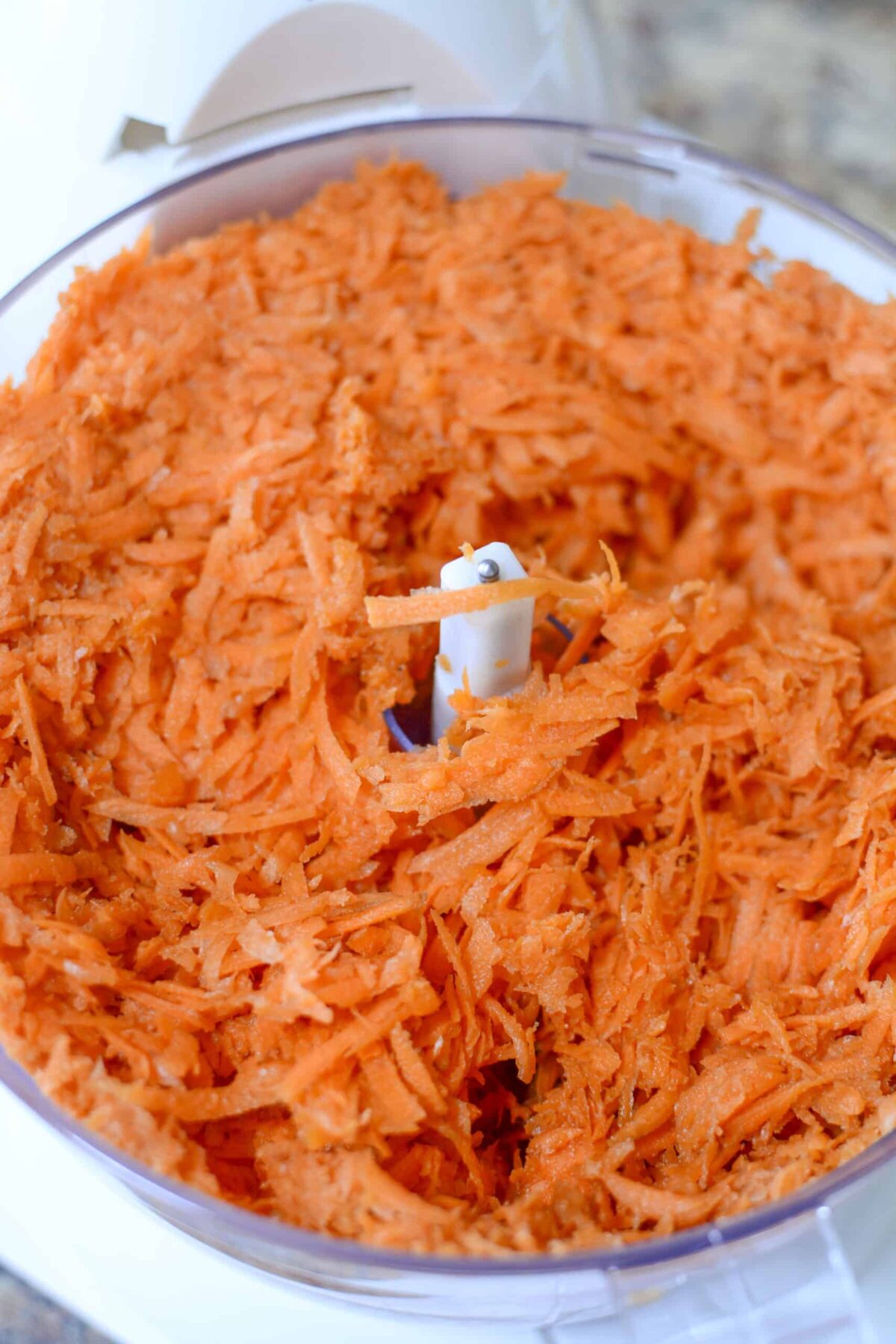 Shredded carrot in the food processor.
