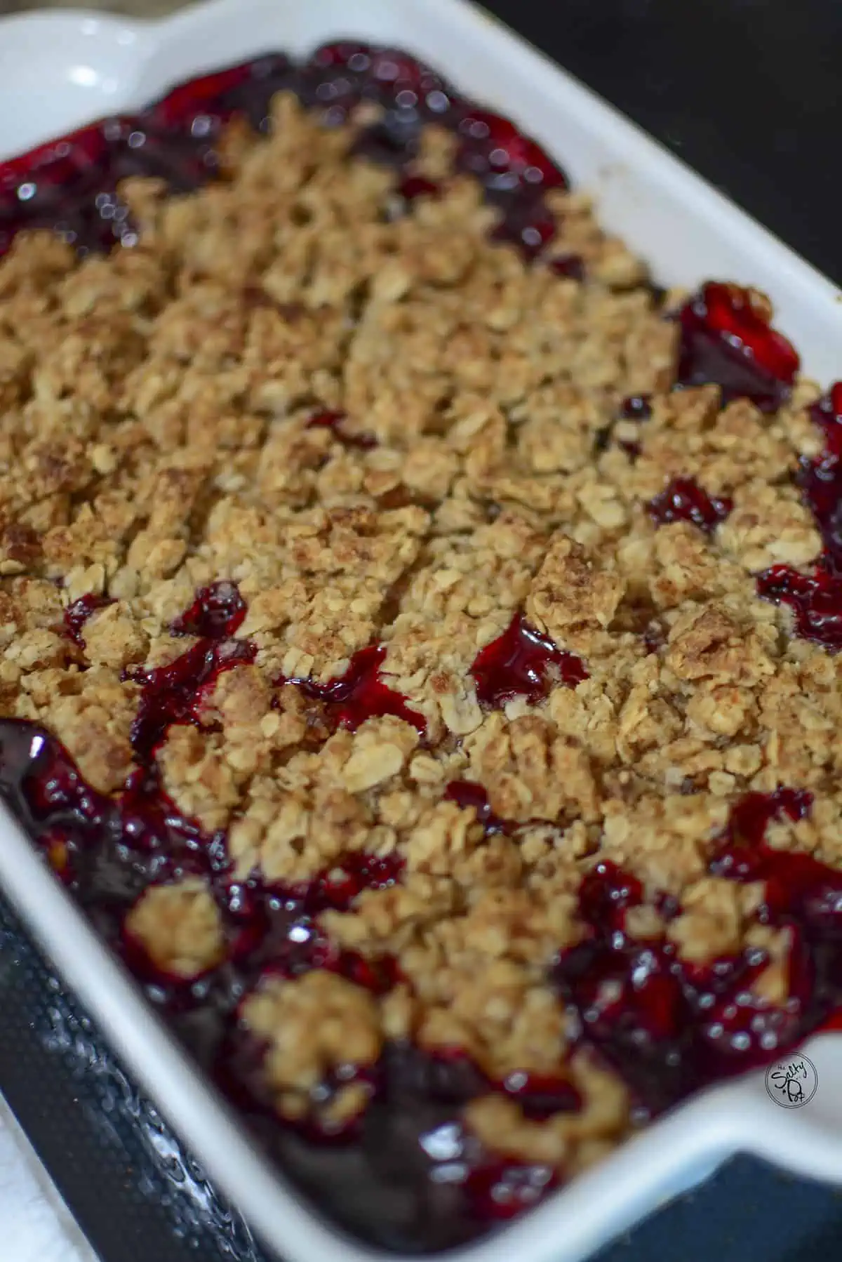 Sour cherry crisp dessert in the baking pan, fresh out of the oven.
