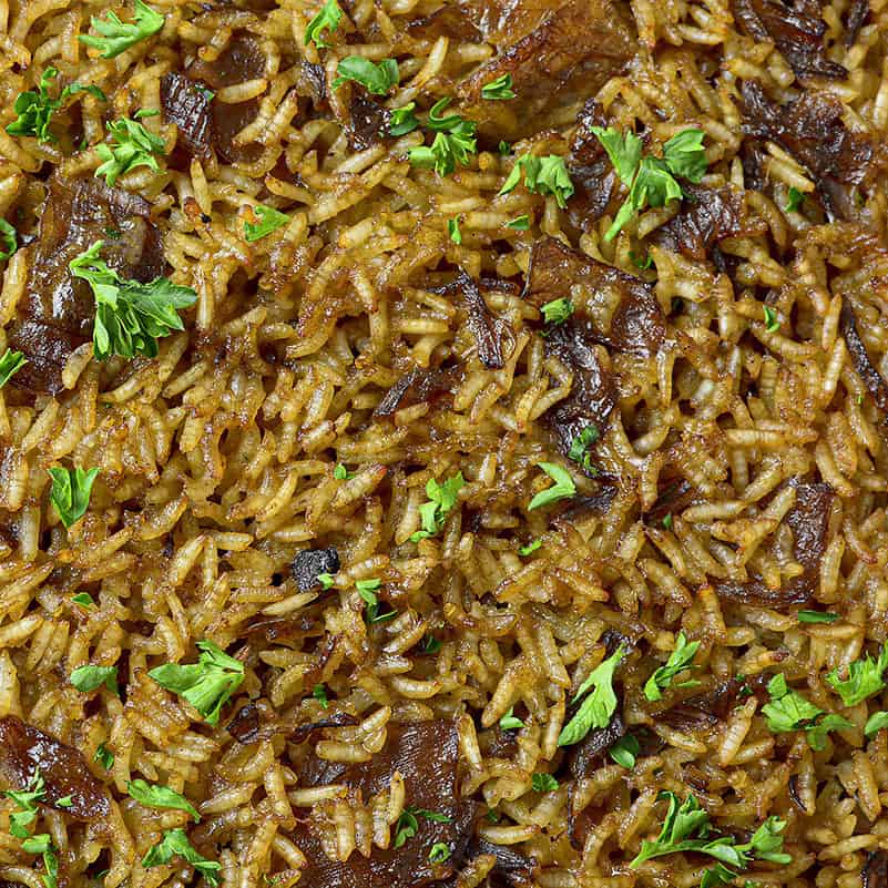 Stick of butter rice photographed up close garnished with parsley.