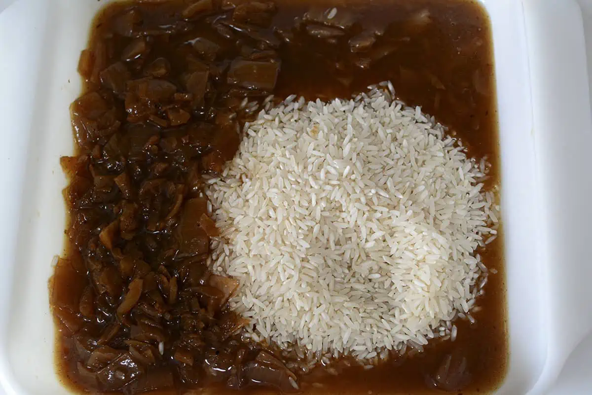 Rice and the onion soup with the beef broth in a baking dish.