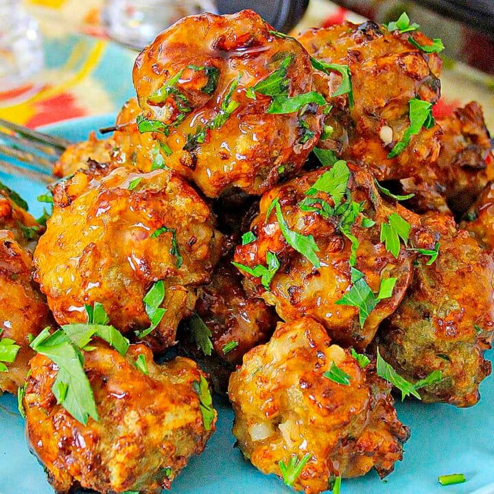 Air Fryer Meatballs on a blue plate with parsley garnish.