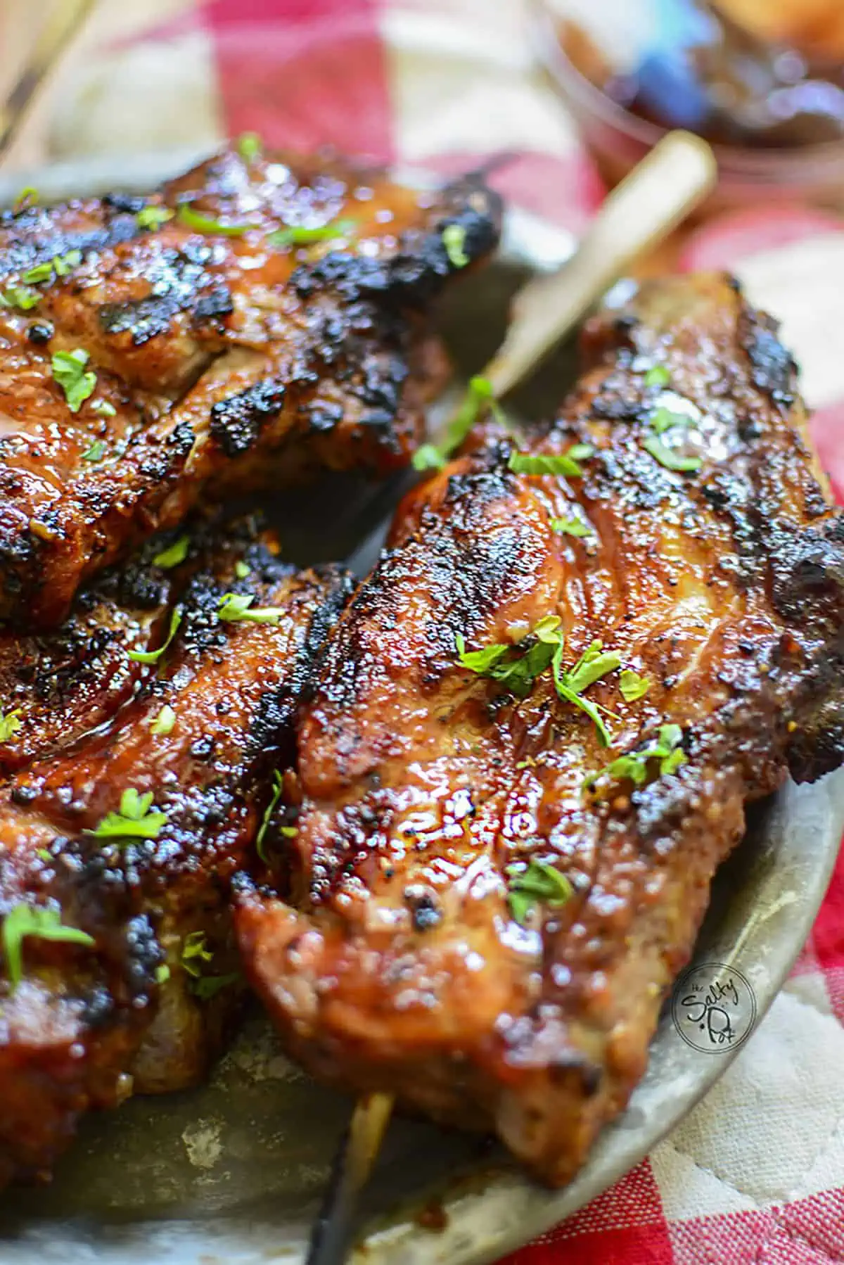 Bonless rib that's been grilled to perfection. Green parsley dots the top of the ribs.