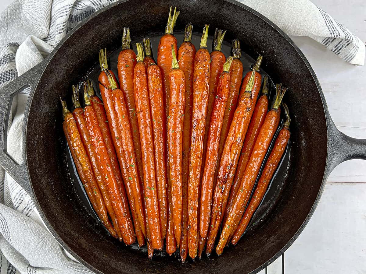 Brown Sugar Honey Glazed Carrots in a cast iron frying pan. 