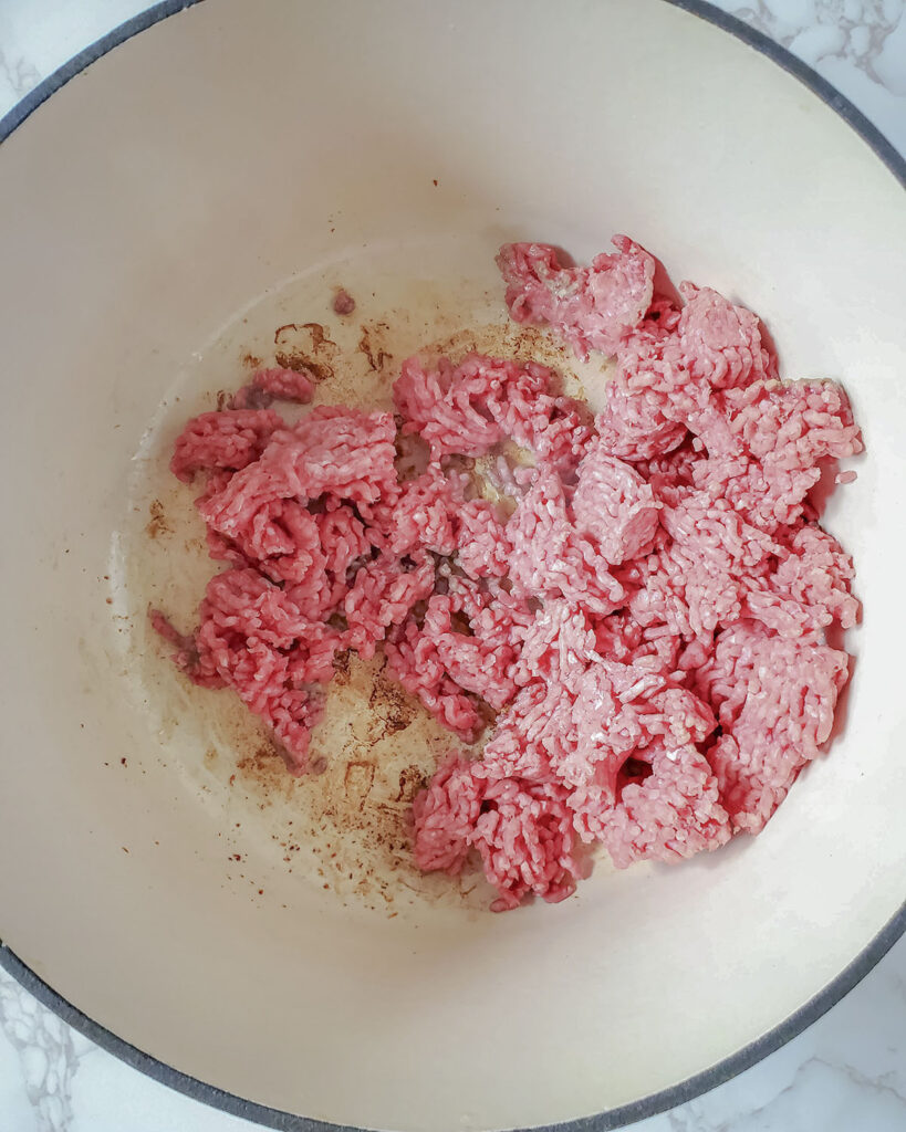 Ground beef being sauteed in the pot. 